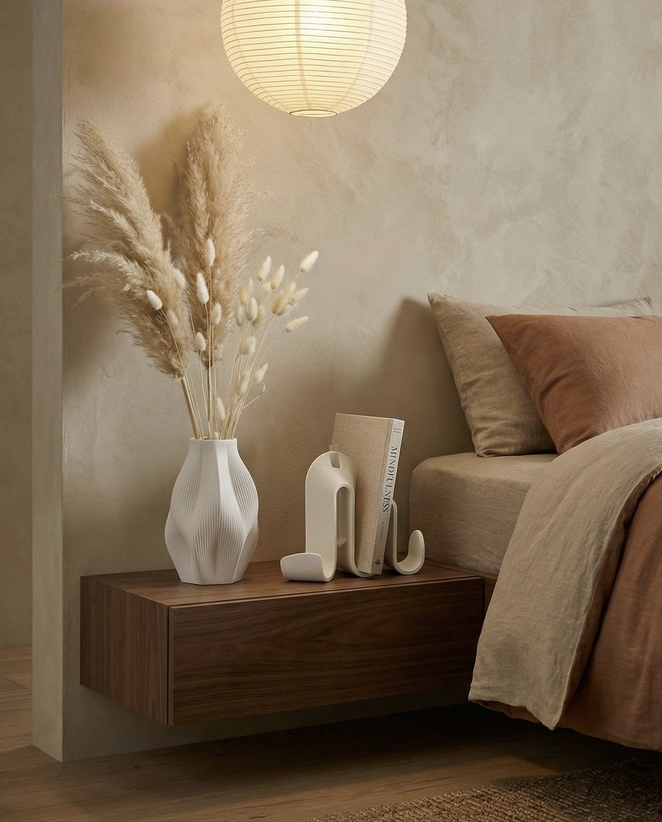 Cozy bedroom with, wooden side table, with a Amini Vase and Amini Book Holder on it.