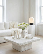 AMINI STRIA Complete Set in White — all four pieces in a bright minimalist living room with white freesias on a stone coffee table, lamp on white pedestal