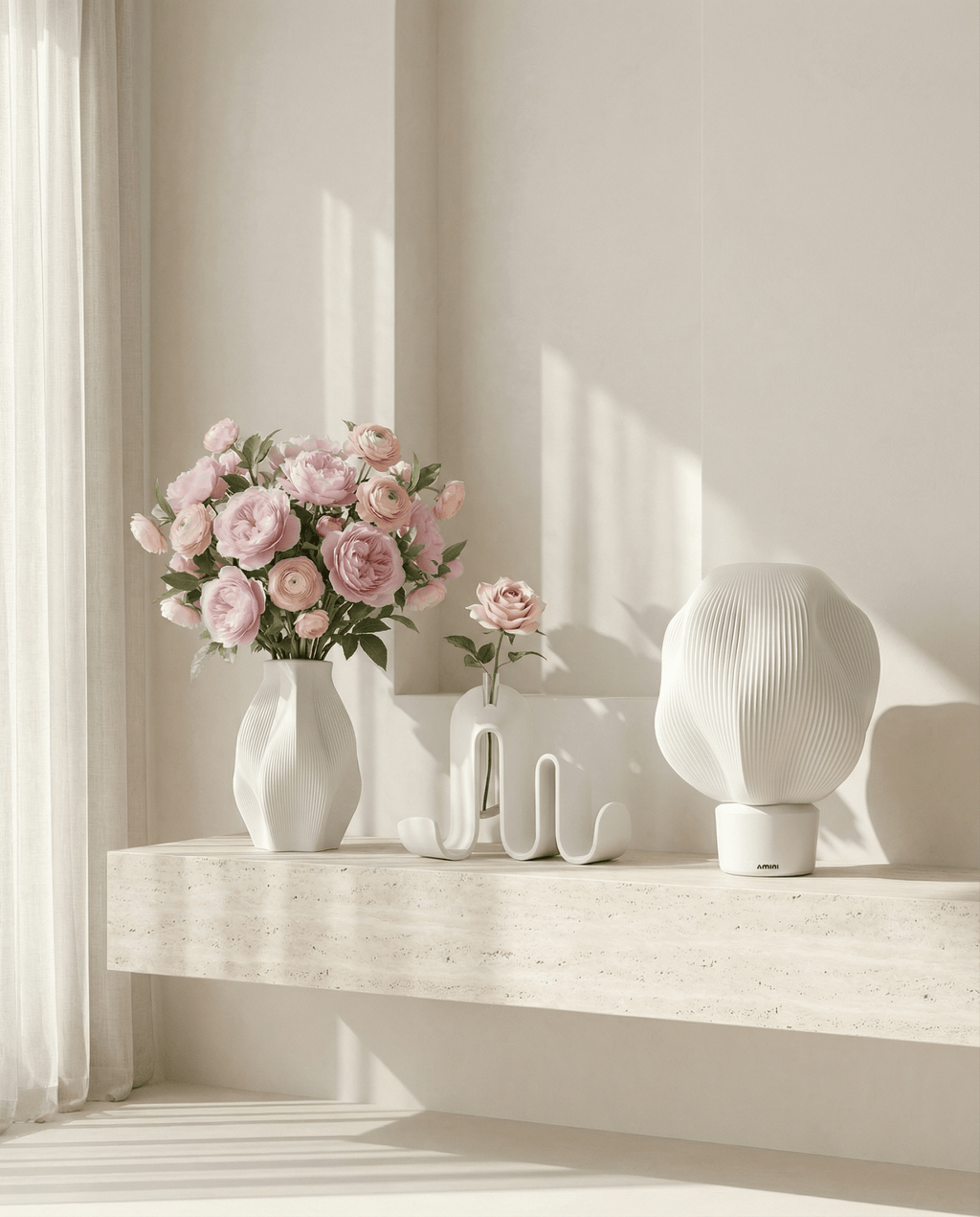AMINI STRIA Core Set in White — vase with pink ranunculus, book holder and lamp on a travertine ledge in a bright room