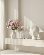 AMINI STRIA Core Set in White — vase with pink ranunculus, book holder and lamp on a travertine ledge in a bright room