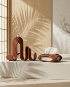 AMINI STRIA Entry Set in Terracotta — book holder and tissue holder on a stone surface with wood slat wall and palm shadows