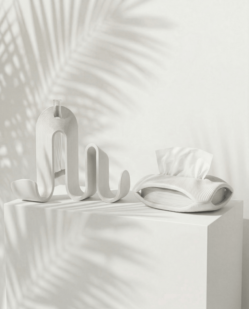AMINI STRIA Entry Set in White — book holder and tissue holder on a white cube with palm shadows