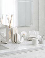 AMINI STRIA Entry Set in White — book holder with reed diffuser and tissue holder on a marble bathroom countertop with white orchid