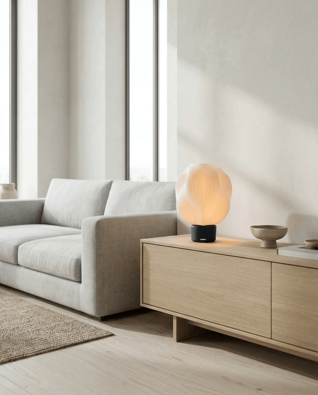 AMINI STRIA Lamp in Charcoal — on a light wood sideboard in a bright modern living room with grey sofa