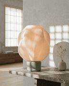 AMINI STRIA Lamp in Pistachio — close-up on a stone surface with dried flower vase and dramatic natural light