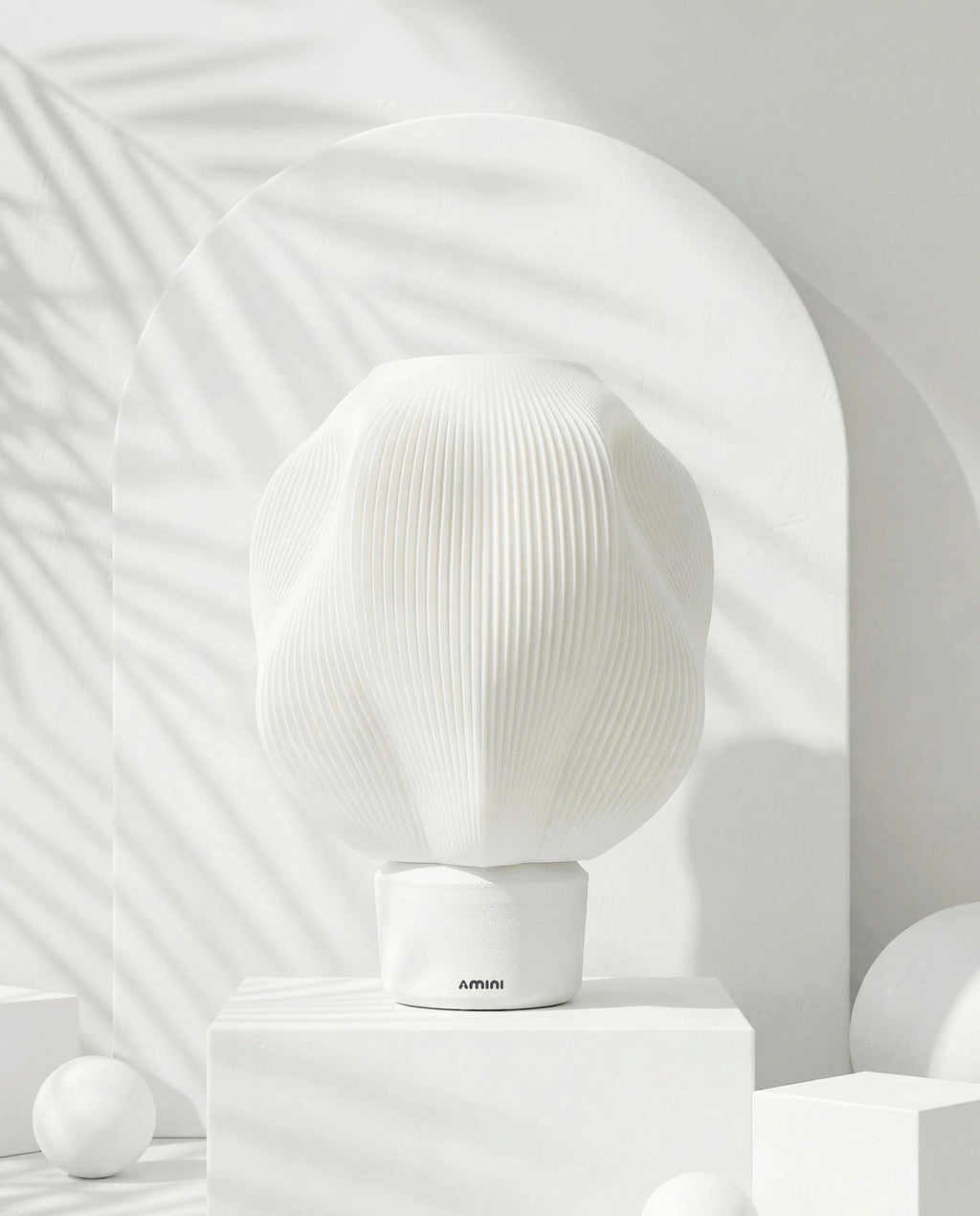 AMINI STRIA Lamp in White — studio shot with arch backdrop and white spheres