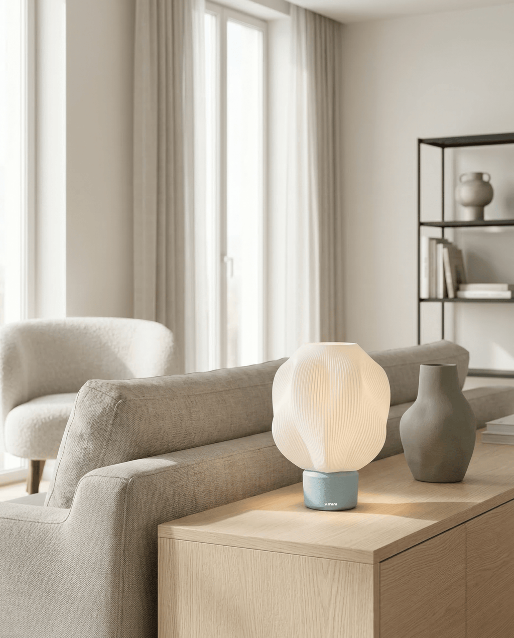 AMINI STRIA Lamp in Baby Blue — on a sideboard in a bright modern living room with grey ceramic vases