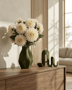 AMINI STRIA Living Set in Olive — vase with cream dahlias beside book holder on a dark walnut sideboard with wood slat wall