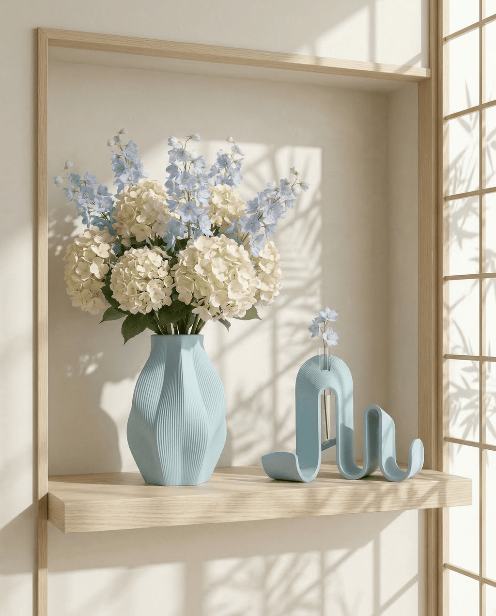 AMINI STRIA Living Set in Baby Blue — vase with white hydrangeas and blue delphiniums beside book holder in a Japanese-style shelf niche