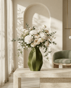 AMINI STRIA Vase in Olive — with white peonies and eucalyptus on a marble table in an elegant interior