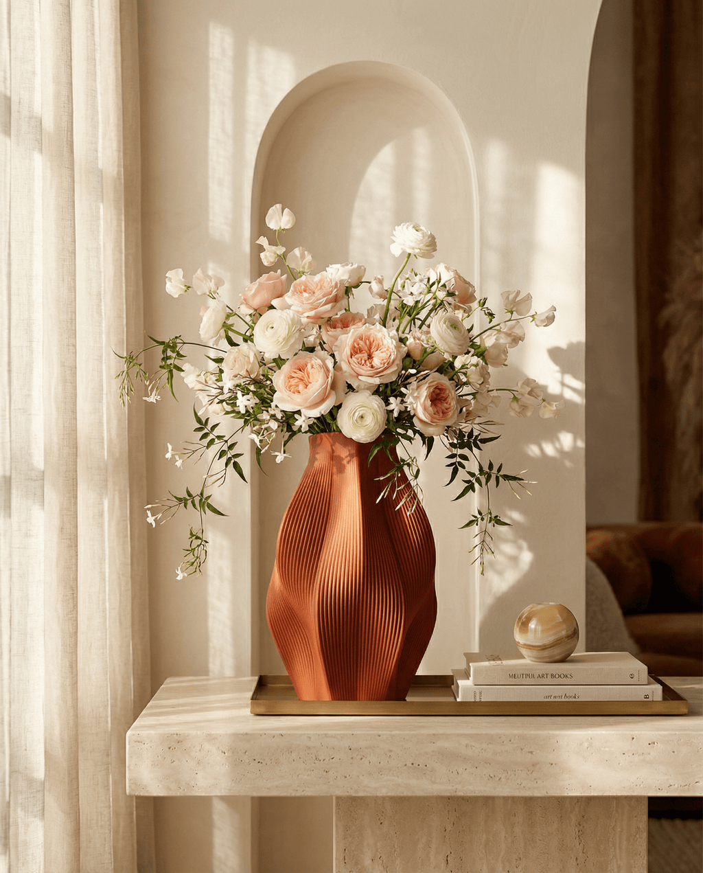 AMINI STRIA Vase in Terracotta — with peach roses and white flowers on a marble console with art books